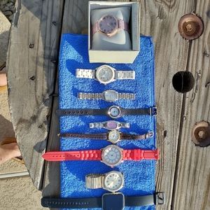 Lot of nine previously enjoyed men's and women's watches as is needs batteries